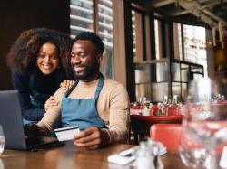 black business owners looking at computer on a table